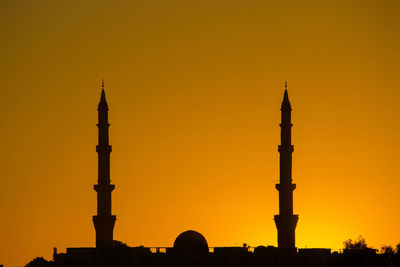 Silhouette of building against sky during sunset