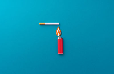 High angle view of electric lamp against blue background