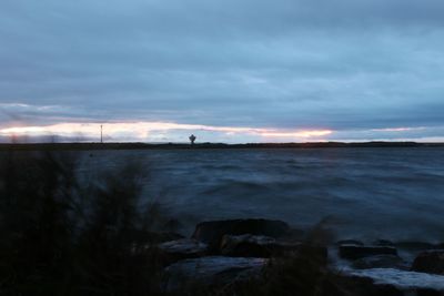 Scenic view of sea against cloudy sky