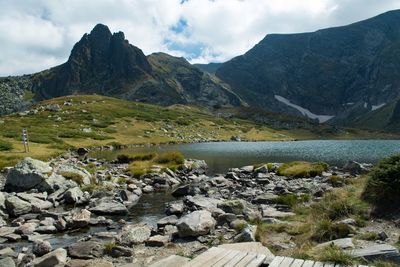 Scenic view of lake and mountains against sky