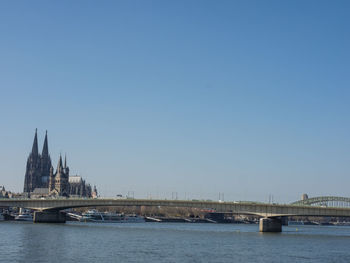 View of bridge over river against clear sky