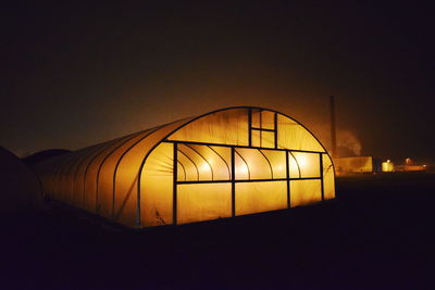 Silhouette illuminated light against clear sky at night