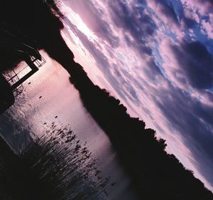 Reflection of clouds in sea at sunset