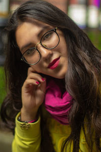 Portrait of young woman wearing lipstick and eyeglasses at home