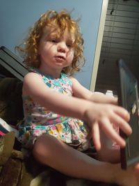 Girl looking away while sitting at home