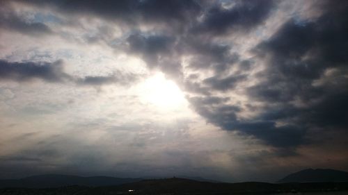 Scenic view of mountains against cloudy sky