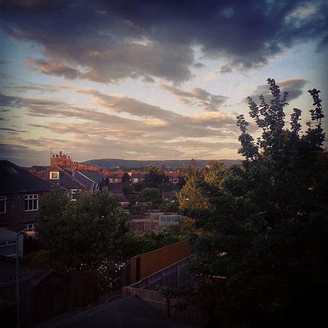 building exterior, architecture, built structure, sky, residential structure, tree, residential building, house, city, residential district, cloud - sky, cityscape, high angle view, town, sunset, cloud, outdoors, dusk, street, townscape