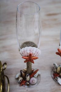 High angle view of champagne flute with seashells on table