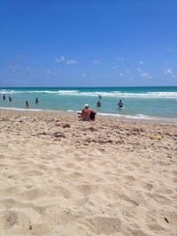 Scenic view of beach against blue sky