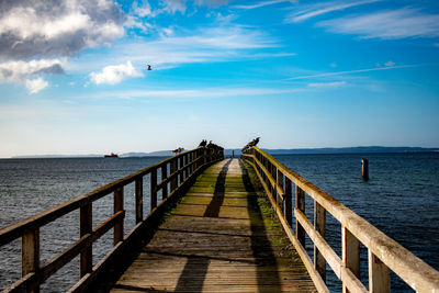 Pier over sea against sky