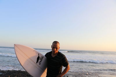 Man on beach against clear sky