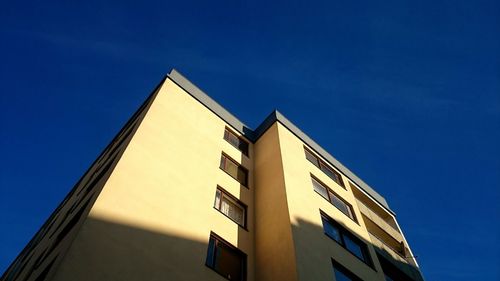 Low angle view of building against blue sky