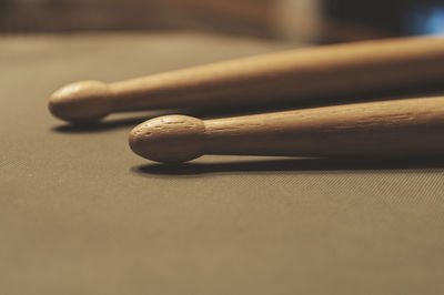 Close-up of wooden drumsticks on table