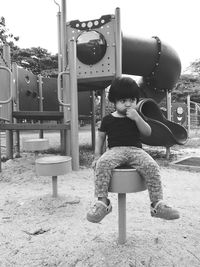 Portrait of cute girl sitting on seat