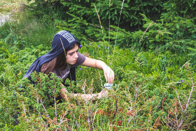 Cute girl working amidst plants