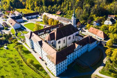 High angle view of houses amidst trees and buildings