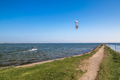 Scenic view of sea against blue sky