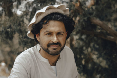 Portrait of man sitting outdoors