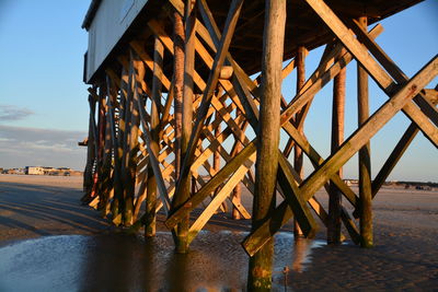 Pier over beach against sky