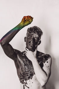 Rear view of shirtless man standing against white background