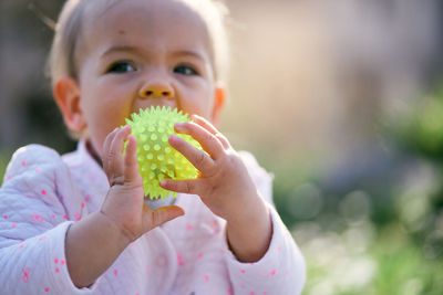 Close-up of cute girl playing outdoors