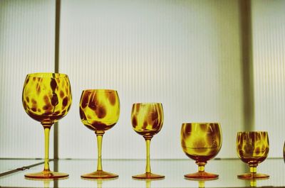 Close-up of wine glasses on table