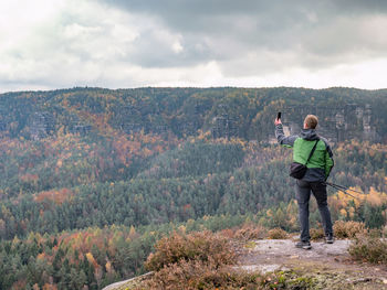 Rear view of man photographing
