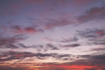 Low angle view of cloudy sky at sunset