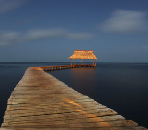 Pier over sea against sky