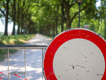 Close-up of road sign against trees