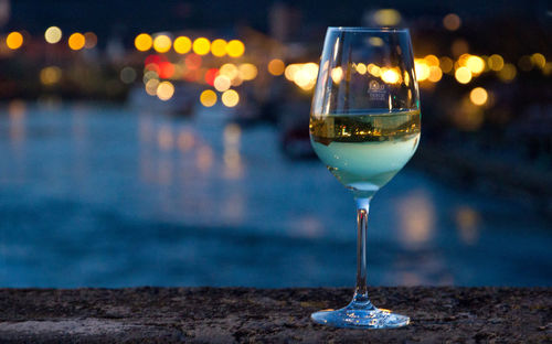 Close-up of wine glass on table at night