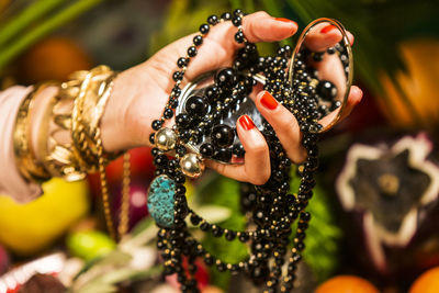 Close-up of woman hand holding multi colored leaves