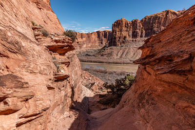 Full frame scenic view of sandstone rock formations against clear blue sky