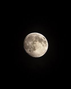 Low angle view of moon against sky at night