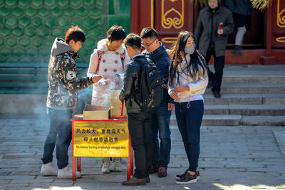 People walking on street in city