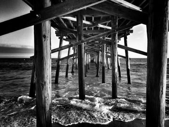 Under view of pier over sea