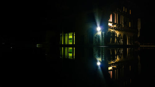 Reflection of illuminated building in water at night