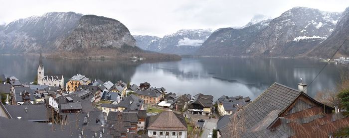 Panoramic view of lake and buildings against sky