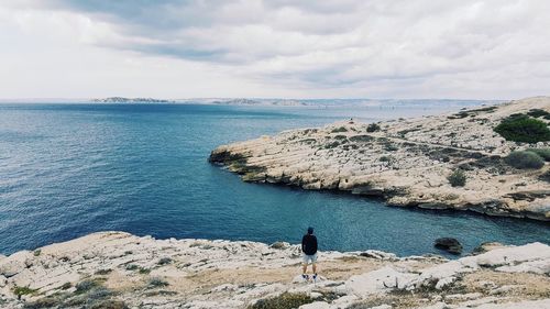 Man standing on calm beach