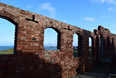 Low angle view of old ruins against sky