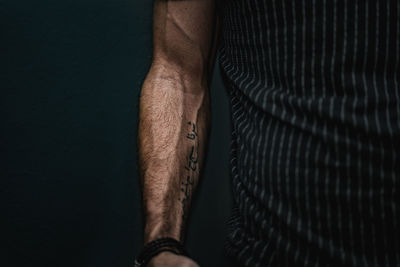 Close-up of man hand against black background