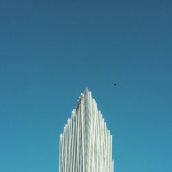 Low angle view of bird flying against clear sky