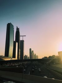 City buildings against clear sky during sunset