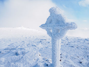 Scenic view of snow covered field against sky