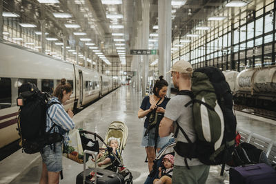 Group of parents with babies waiting at train station