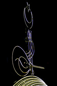 Low angle view of light painting against black background