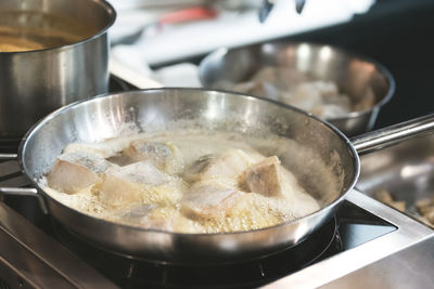 Close-up of fish frying in cooking pan