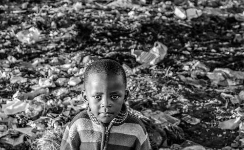 Portrait of boy against garbage