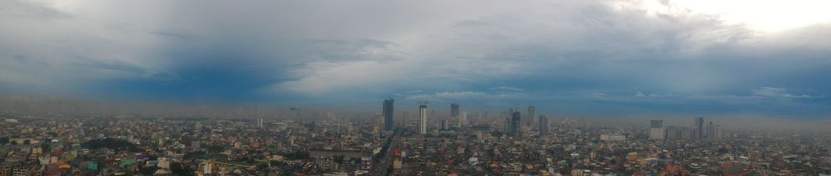 Panoramic view of city buildings against sky