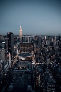 Aerial view of illuminated cityscape against sky